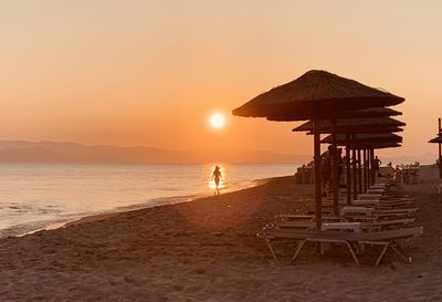 Scenic view of beach against sky during sunset