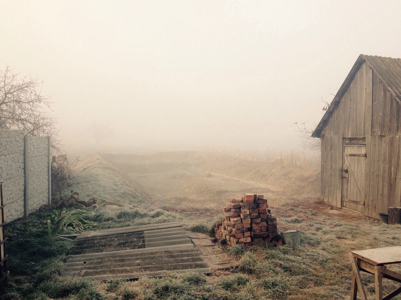 built structure, architecture, building exterior, landscape, fog, house, copy space, sky, tranquility, nature, tranquil scene, day, abandoned, field, old, mountain, foggy, scenics, outdoors