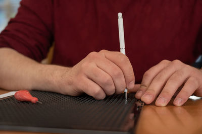 Midsection of man using laptop