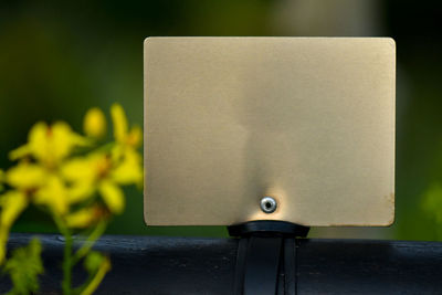 Close-up of paper on table against wall