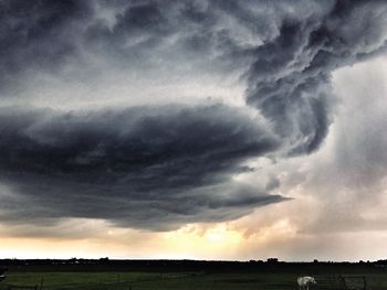 Storm clouds over field