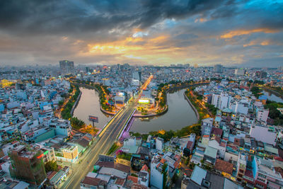 High angle view of illuminated city buildings against sky