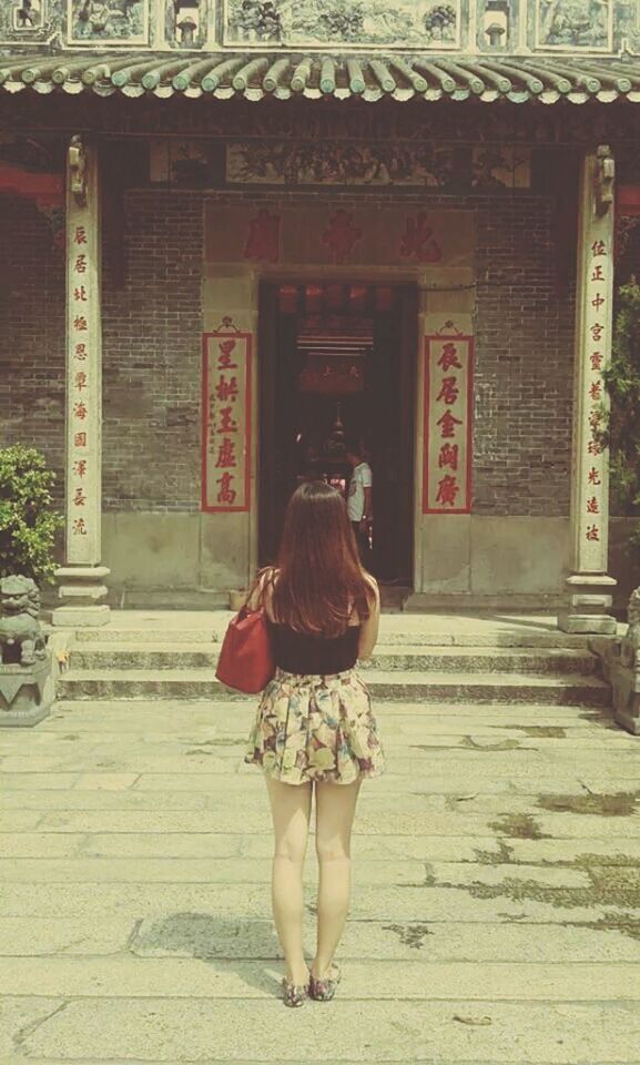 lifestyles, full length, casual clothing, architecture, built structure, building exterior, rear view, text, standing, leisure activity, young adult, young women, person, front view, communication, street, three quarter length, walking
