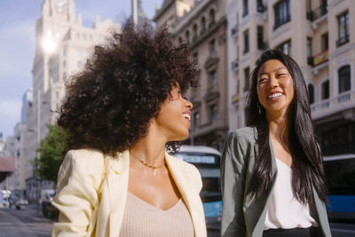 Happy multiracial friends talking to each other