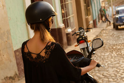 Rear view of woman riding motorcycle