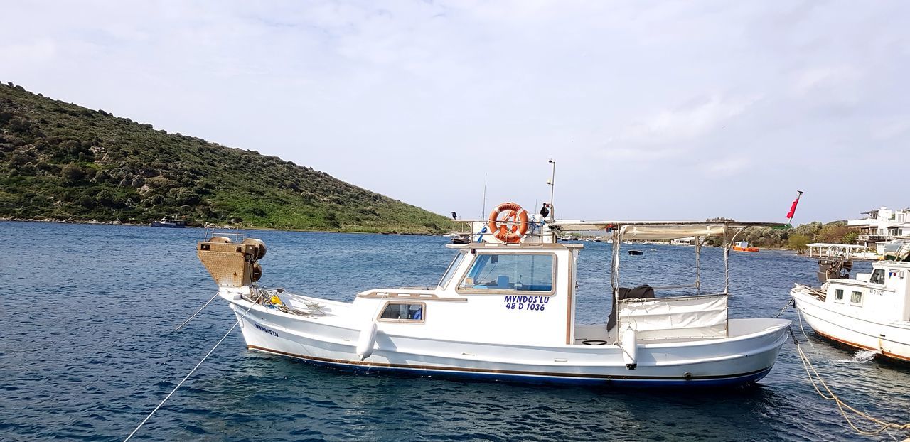 nautical vessel, mode of transport, sky, water, sea, transportation, boat, nature, day, waterfront, cloud - sky, moored, outdoors, scenics, no people, beauty in nature, horizon over water, tree, animal themes