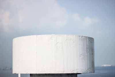 Low angle view of white wall against sky