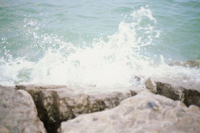 Waves splashing on rocks at beach