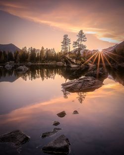 Scenic view of lake against sky during sunset