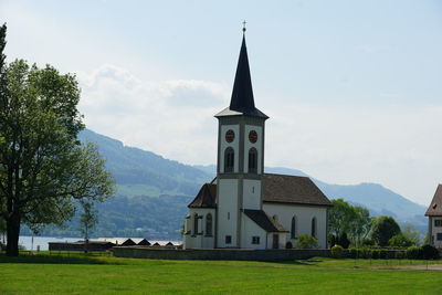 Church by building against sky