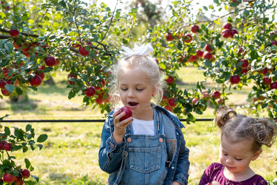 Happy girl and fruits on plant