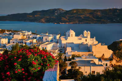 Scenic view of sea by buildings against sky