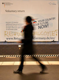 Blurred motion of woman walking on wall