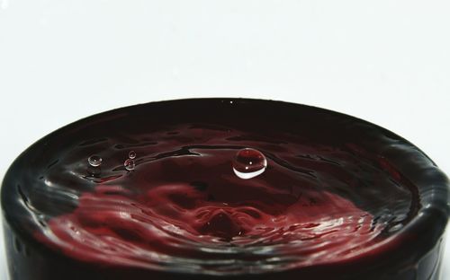 Close-up of water drops against red background