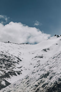 Scenic view of snow covered mountains against sky