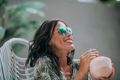 Portrait of a smiling young woman holding ice cream