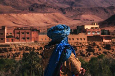 Rear view of woman standing on mountain