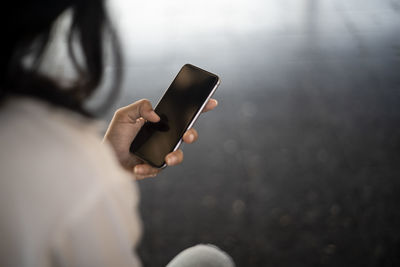 Midsection of woman using mobile phone