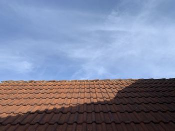 Low angle view of roof and building against sky