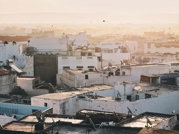 High angle view of buildings against sky during sunset