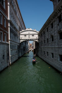 View of canal along buildings in venice