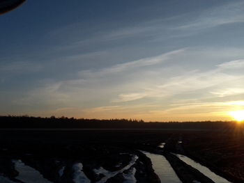 Scenic view of field against sky during sunset