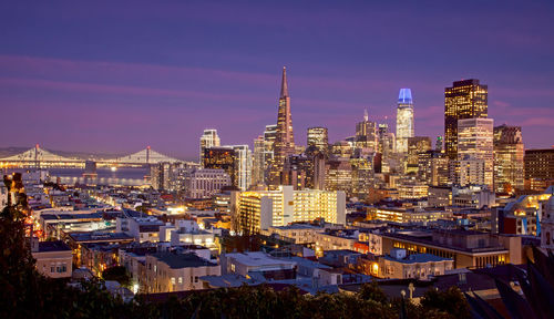 Illuminated cityscape against sky