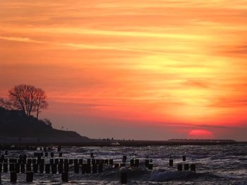 Scenic view of sea against romantic sky at sunset