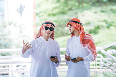 Business colleagues wearing traditional clothing while standing outdoors