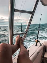 Low section of woman relaxing on yacht