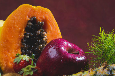 Close-up of apple on table against orange background