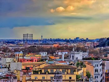 View of cityscape against cloudy sky