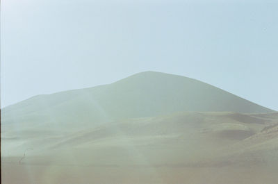 Scenic view of desert against clear sky