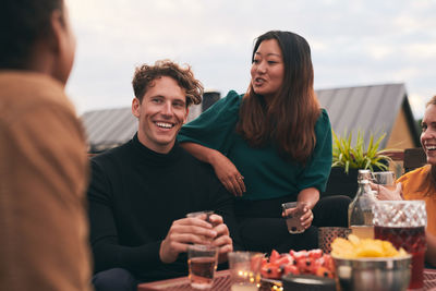 Happy young woman having food outdoors