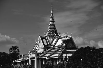 Low angle view of traditional building against cloudy sky