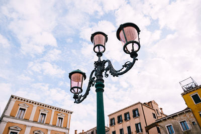 Low angle view of street light against building