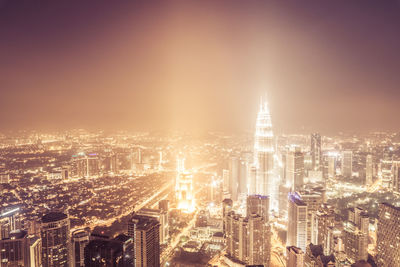 Aerial view of illuminated buildings in city