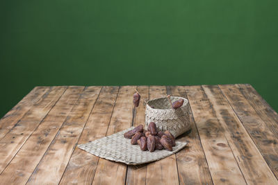 High angle view of bird perching on wooden table