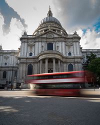 Blurred motion of bus on road against st paul cathedral