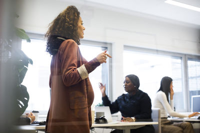 Businesswoman with male and female colleagues working in office