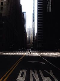 Man walking on city street against cityscape