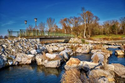 Arch bridge over river against sky