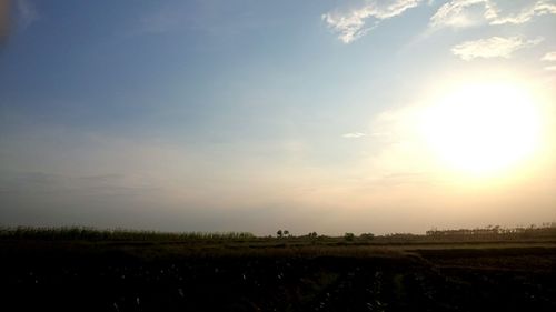 Scenic view of field against sky at sunset