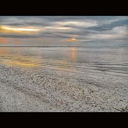 Scenic view of sea against cloudy sky