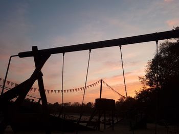 Low angle view of silhouette bridge against sky during sunset