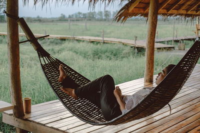 Man lying down on hammock