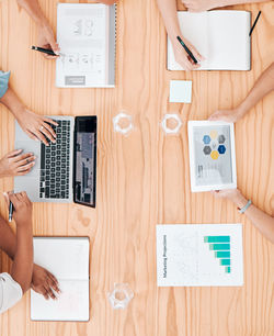 High angle view of business colleagues working on table