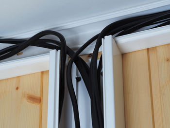Close-up of electric hanging on cable at home