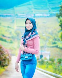 Portrait of young woman standing outdoors