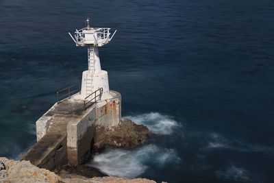High angle view of lighthouse amidst sea